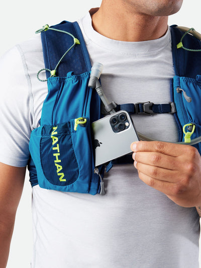 color:Deep Blue/Safety Yellow||seo:Nathan VaporAir 3.0 7 Liter Men's Hydration Pack - Deep Blue/Safety Yellow - On Model - Pulling Cell Phone From Pocket