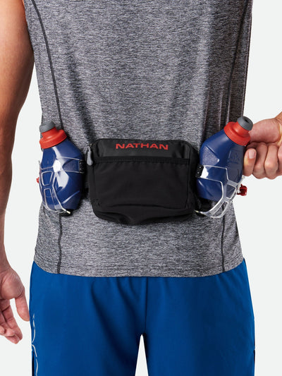 color:Black/Ribbon Red||seo:Nathan TrailMix Plus Hydration Belt 3.0 - Black/Ribbon Red - On Model - Pulling Flask From Carrier