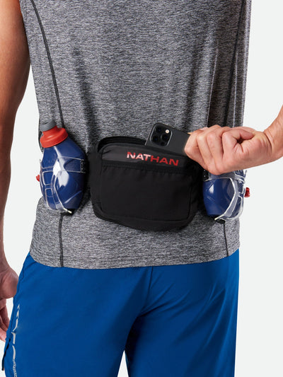 color:Black/Ribbon Red||seo:Nathan TrailMix Plus Hydration Belt 3.0 - Black/Ribbon Red - On Model - Pulling Cell Phone From Pocket