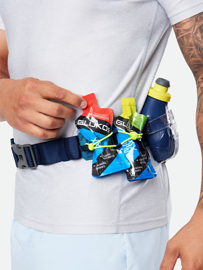 color:Deep Blue/Safety Yellow||seo:Nathan TrailMix Plus Hydration Belt 3.0 - Deep Blue/Safety Yellow - On Model - Detail View of Elastic Keepers Holding Glukos Energy Gels and Hydration Flask