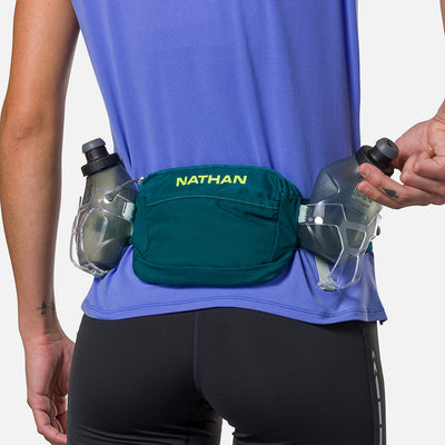 color:Deep Teal/Finish Lime||view:sku image back||seo:Nathan TrailMix Plus Hydration Belt 3.0 - Deep Teal/Finish Lime - On Model - Pulling Flask From Carrier