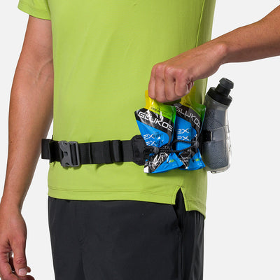 color:Black/Reflective Silver||seo:Nathan TrailMix Plus Insulated Hydration Waist Belt 3.0 - Black/Reflective Silver - Detail View of Elastic Keepers Holding Glukos Energy Gels (Lemon Lime Flavor)