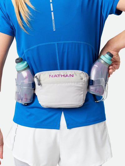color:Vapor Grey/Magenta||view:sku image back||seo:Nathan TrailMix Plus Insulated Hydration Belt 3.0 - Vapor Grey/Magenta - On Model - Pulling Flask From Carrier