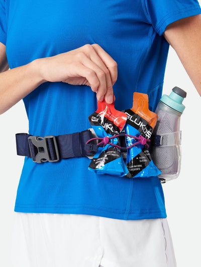 color:Vapor Grey/Magenta||seo:Nathan TrailMix Plus Insulated Hydration Belt 3.0 - Vapor Grey/Magenta - On Model - Detail View of Elastic Keepers Holding Glukos Energy Gels (Fruit Punch & Orange Flavor)