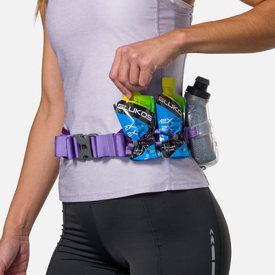color:Imperial Purple/Paisley Purple||seo:Nathan TrailMix Plus Insulated Hydration Waist Belt 3.0 - Imperial Purple/Paisley Purple - Detail View of Elastic Keepers Holding Glukos Energy Gels (Lemon Lime Flavor)