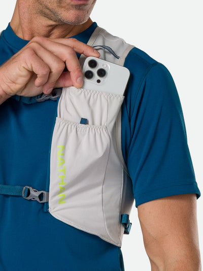 color:Vapor Grey||seo:Nathan Pinnacle FeatherLite 1.5 Liter Unisex Hydration Vest - Vapor Grey - Female Runner Pulling iPhone From Front Storage Pocket