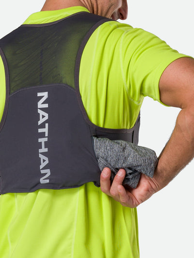 color:Charcoal/Reflective Silver||seo:Nathan Pinnacle FeatherLite 1.5 Liter Unisex Hydration Vest - Charcoal/Reflective Silver - Male Runner Pulling Long Sleeve Shirt from Kangaroo Pocket