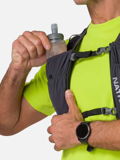 color:harcoal/Reflective Silve||seo:Nathan Pinnacle FeatherLite 1.5 Liter Unisex Hydration Vest - Charcoal/Reflective Silve - Male Runner Pulling 14oz (414 ml) Flask From Front Storage Pocket