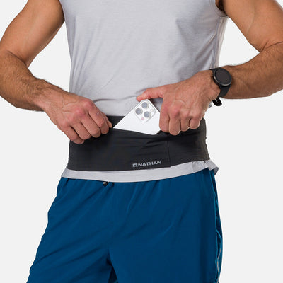 ccolor:Black||seo: Nathan Zipster Max Training Waist Belt - Black - Model Pulling Out iPhone From Storage Pocket