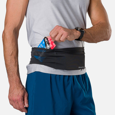 color:Black||seo: Nathan Zipster Max Training Waist Belt - Black - Model Pulling Glukos Energy Gel (Fruit Punch Flavor) out of Side Storage Pocket