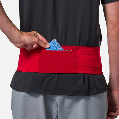 color:Ribbon Red/Reflective Silver||seo: Nathan Zipster Max Training Waist Belt - Ribbon Red/Reflective Silver - Model Pulling Credit Card out of Zippered Pocket