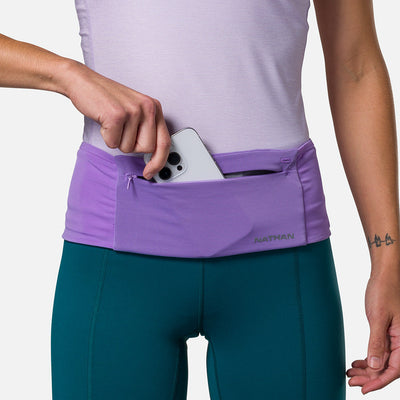 color:Paisley Purple/Imperial Purple||seo: Nathan Zipster Max Training Waist Belt - Paisley Purple/Imperial Purple - Model Pulling Out iPhone From Storage Pocket