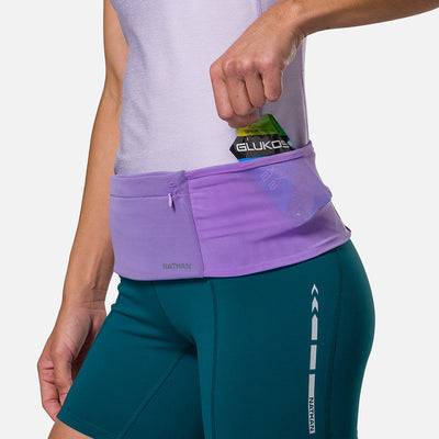 color:Paisley Purple/Imperial Purple||seo: Nathan Zipster Max Training Waist Belt - Paisley Purple/Imperial Purple - Model Pulling Glukos Energy Gel (Lemon Lime Flavor) out of Side Storage Pocket