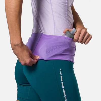 color:Paisley Purple/Imperial Purple||seo: Nathan Zipster Max Training Waist Belt - Paisley Purple/Imperial Purple - Model Pulling Hydration Flask Out of Side Storage Pocket