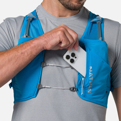 color:Electric Blue/Reflective Silver||seo:Nathan Pinnacle Breeze 4 Liter Unisex Hydration Race Vest - Electric Blue/Reflective Silver - Model Pulling iPhone from Front Pouch