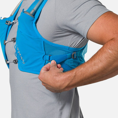 color:Electric Blue/Reflective Silver||seo:Nathan Pinnacle Breeze 4 Liter Unisex Hydration Race Vest - Electric Blue/Reflective Silver - Model Adjusting QuickFit Size System to Adjust Around His Body