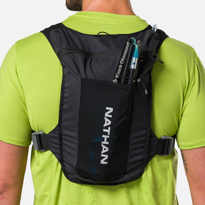 color:Black/Reflective Silver||seo:Nathan QuickStart 3.0 4 Liter Hydration Pack - Black/Reflective Silver - On Model - Large back expandable mesh pocket perfect for clothes, gear and other larger essentials, plus elastic pole keeper