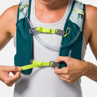 color:Deep Teal/Reflective Silver||seo:Nathan QuickStart 3.0 4 Liter Hydration Pack - Deep Teal/Reflective Silver - On Model - Model Tightening Sternum Straps For Better Fit