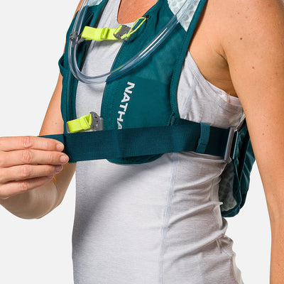 color:Deep Teal/Reflective Silver||seo:Nathan QuickStart 3.0 4 Liter Hydration Pack - Deep Teal/Reflective Silver - On Model - Model Adjusting Wide Side Straps For a Secure No Bounce Fit