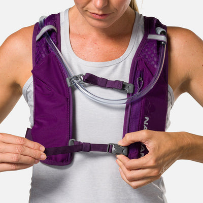 color:Imperial Purple/Reflective Silver||seo:Nathan QuickStart 3.0 4 Liter Hydration Pack - Imperial Purple/Reflective Silver - On Model - Model Tightening Sternum Straps For Better Fit