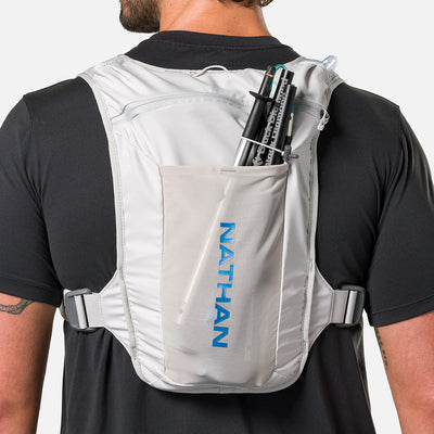 color:Vapor Grey/Deep Blue||seo:Nathan QuickStart 3.0 4 Liter Hydration Pack - Vapor Grey/Deep Blue - On Model - Large back expandable mesh pocket perfect for clothes, gear and other larger essentials, plus elastic pole keeper