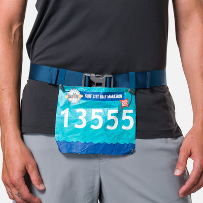 color:Sailor Blue/Reflective Silver||view:sku image back||seo:Nathan Pinnacle FeatherLite Unisex Hydration Waist Belt - Sailor Blue/Reflective Silver - Model Wearing Clip On Race Belt For Surf City Half Marathon