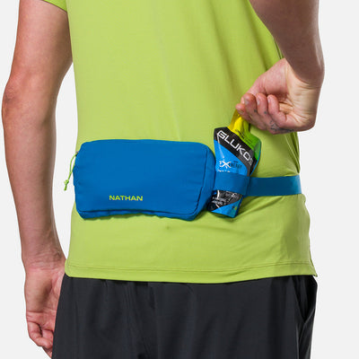color:Deep Blue/Finish Lime||seo:Nathan Marathon Waist Pack 3.0 - Deep Blue/Finish Lime - On Model - Pulling Glukos Energy Gel (Lemon Lime Flavor) From Keeper