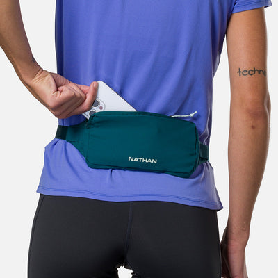color:Deep Teal/Surf Spray||seo:Nathan Marathon Waist Pack 3.0 - Deep Teal/Surf Spray - On Model - Pulling iPhone Phone From Storage Pocket