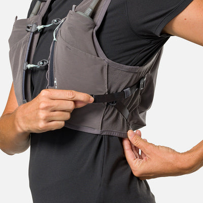 color:Charcoal/Surf Spray||seo:Nathan Pinnacle Breeze 4 Liter Women's Hydration Race Vest - Charcoal/Surf Spray - Model Adjusting QuickFit Size System to Adjust Around Her Body