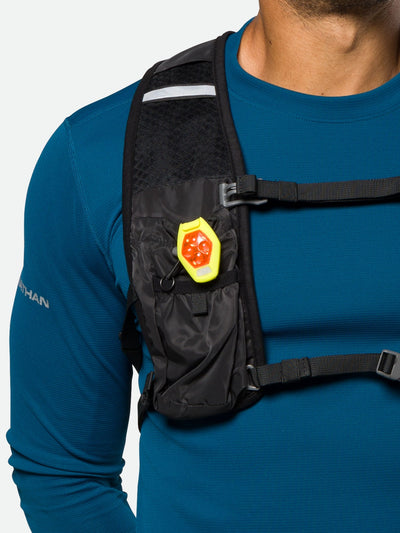 color:Safety Yellow||seo:Nathan HyperBrite RX Strobe Rechargeable LED Clip Light - Safety Yellow – On Model - Clip Light Attached to Hydration Vest