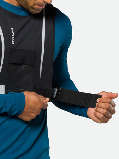 Nathan Hypernight Reflective Stash Vest – Black – On Model – Tightening Waist Straps for Better Fit
