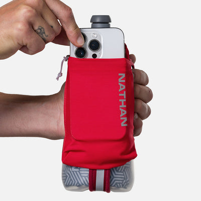 color:Ribbon Red/Reflective Silver||seo:Nathan SpeedDraw 2 Insulated 18oz Handheld Flask - Ribbon Red/Reflective Silver - Model Pulling iPhone from Pouch