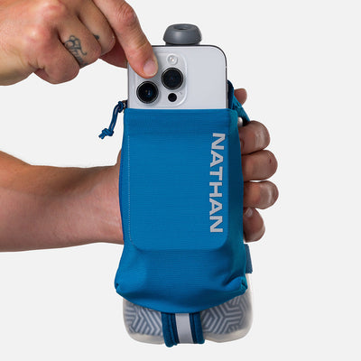 color:Deep Blue/Reflective Silver||seo:Nathan SpeedDraw 2 Insulated 18oz Handheld Flask - Deep Blue/Reflective Silver - Model Pulling iPhone from Pouch