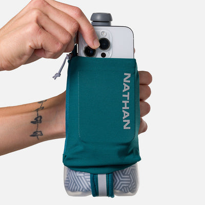 color:Deep Teal/Reflective Silver||seo:Nathan SpeedDraw 2 Insulated 18oz Handheld Flask - Deep Teal/Reflective Silver - Model Pulling iPhone from Pouch