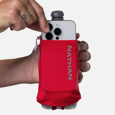 color:Ribbon Red/Reflective Silver||seo:Nathan SpeedDraw 2 Insulated 12oz Handheld Flask - Ribbon Red/Reflective Silver - Model Pulling iPhone from Pouch
