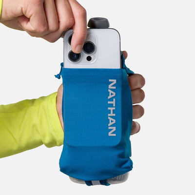 color:Deep Blue/Reflective Silver||seo:Nathan SpeedDraw 2 Insulated 12oz Handheld Flask - Deep Blue/Reflective Silver - Model Pulling iPhone from Pouch