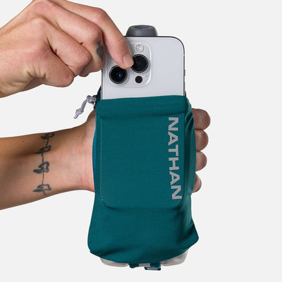 color:Deep Teal/Reflective Silver||seo:Nathan SpeedDraw 2 Insulated 12oz Handheld Flask - Deep Teal/Reflective Silver - Model Pulling iPhone from Pouch
