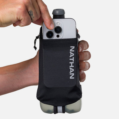 color:Black/Reflective Silver||seo:Nathan SpeedDraw 2 22oz Handheld Flask - Black/Reflective Silver - Model Pulling iPhone from Pouch