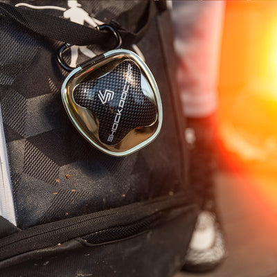 Lifestyle Image of Chrome Gold Mouthguard Case Hanging On Gym Bag