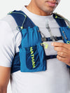 color:Deep Blue/Safety Yellow||seo: Nathan VaporAir 3.0 7 Liter Men's Hydration Pack - Deep Blue/Safety Yellow - On Model - Model Pulling Hose to Sip From High Flow Bite Valve