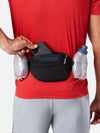 color:Black/Deep Blue||seo:Nathan TrailMix Plus Insulated Hydration Belt 3.0 - Black/Deep Blue - On Model - Pulling Cell Phone From Pocket