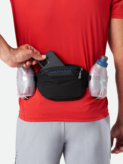 color:Black/Deep Blue||seo:Nathan TrailMix Plus Insulated Hydration Belt 3.0 - Black/Deep Blue - On Model - Pulling Cell Phone From Pocket