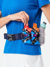 color:Vapor Grey/Magenta||seo:Nathan TrailMix Plus Insulated Hydration Belt 3.0 - Vapor Grey/Magenta - On Model - Detail View of Elastic Keepers Holding Glukos Energy Gels (Fruit Punch & Orange Flavor)