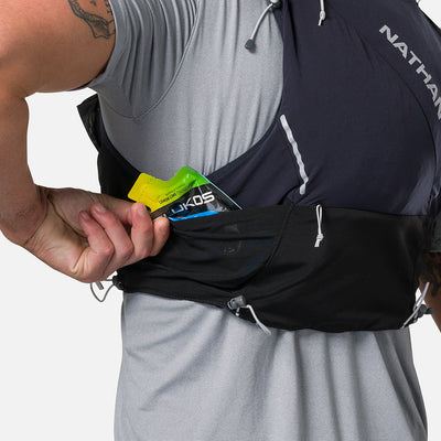 color:Black/Reflective Silver||seo:Nathan Pinnacle Pro 12 Liter Unisex Hydration Race Vest - Black/Reflective Silver - Male Runner Pulling Glukos Energy Gel (Lemon Lime Flavor) From Easy-Access Kangaroo Pocket
