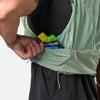 color:Sage Green/Reflective Silver||seo:Nathan Pinnacle Pro 12 Liter Unisex Hydration Race Vest - Sage Green/Reflective Silver - Male Runner Pulling Glukos Energy Gel (Lemon Lime Flavor) From Easy-Access Kangaroo Pocket