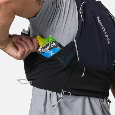 color:Black/Reflective Silver||seo:Nathan Pinnacle Pro 6 Liter Unisex Hydration Race Vest - Black/Reflective Silver - Male Runner Pulling Glukos Energy Gel (Lemon Lime Flavor) From Easy-Access Kangaroo Pocket