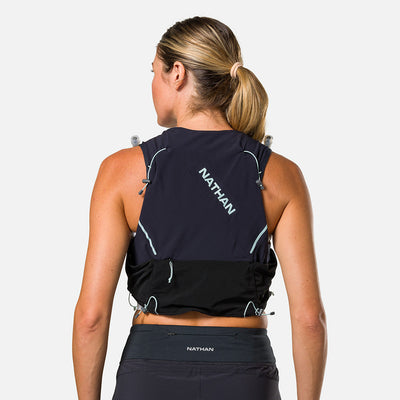 color:Black/Surf Spray||seo:Nathan Pinnacle Pro 6 Liter Women's Hydration Race Vest - Black/Surf Spray - Female Runner Pulling iPhone From Front Storage Pocket