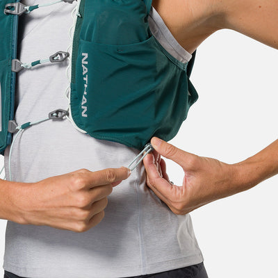 color:Deep Teal/Reflective Silver||seo:Nathan Pinnacle Pro 6 Liter Women's Hydration Race Vest - Deep Teal/Reflective Silver - Model Adjusting QuickFit Size System to Adjust Around HerBody