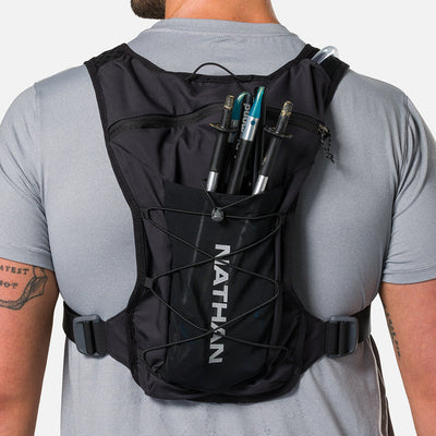 color:Black/Reflective Silver||seo:Nathan QuickStart 3.0 6 Liter Hydration Pack - Black/Reflective Silver - On Model - Large back expandable mesh pocket perfect for clothes, gear and other larger essentials, plus elastic pole keeper