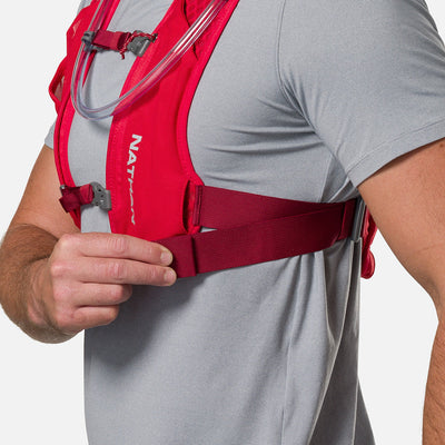 color:Ribbon Red/Reflective Silver||seo:Nathan QuickStart 3.0 6 Liter Hydration Pack - Ribbon Red/Reflective Silver - On Model - Model Adjusting Wide Side Straps For a Secure No Bounce Fit